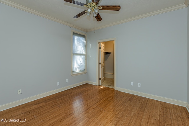 spare room featuring ceiling fan, light wood-type flooring, and crown molding