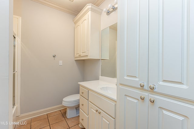 bathroom with tile patterned floors, crown molding, vanity, an enclosed shower, and toilet