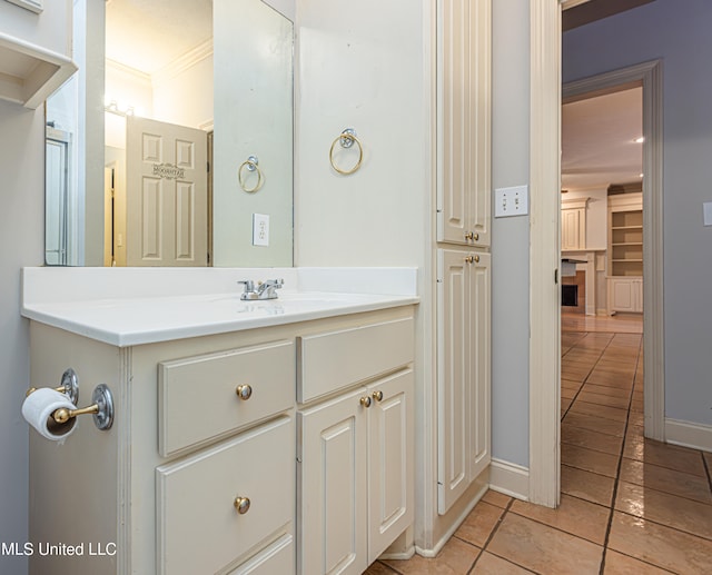 bathroom with vanity, tile patterned floors, and crown molding