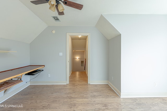 additional living space with light hardwood / wood-style floors, ceiling fan, and vaulted ceiling