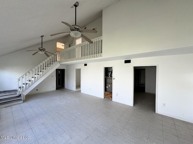 unfurnished living room with ceiling fan, high vaulted ceiling, and a textured ceiling