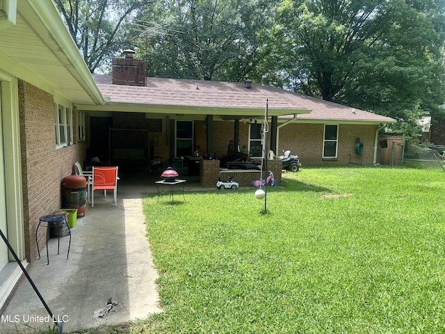 157 Fern Valley Rd, Brandon, MS 39042 - rear view of house with a patio, a yard, brick siding, a chimney, and an outdoor living space