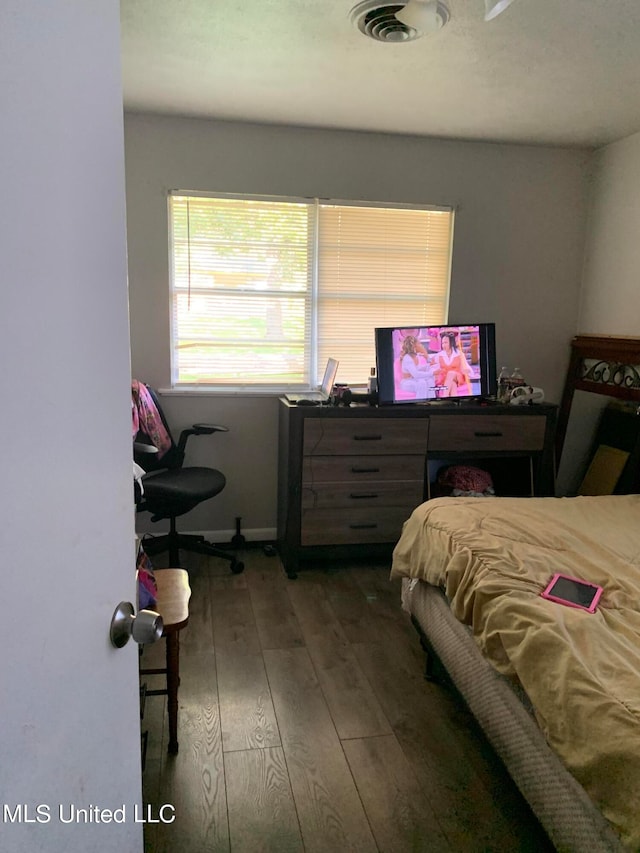 bedroom featuring dark hardwood / wood-style flooring