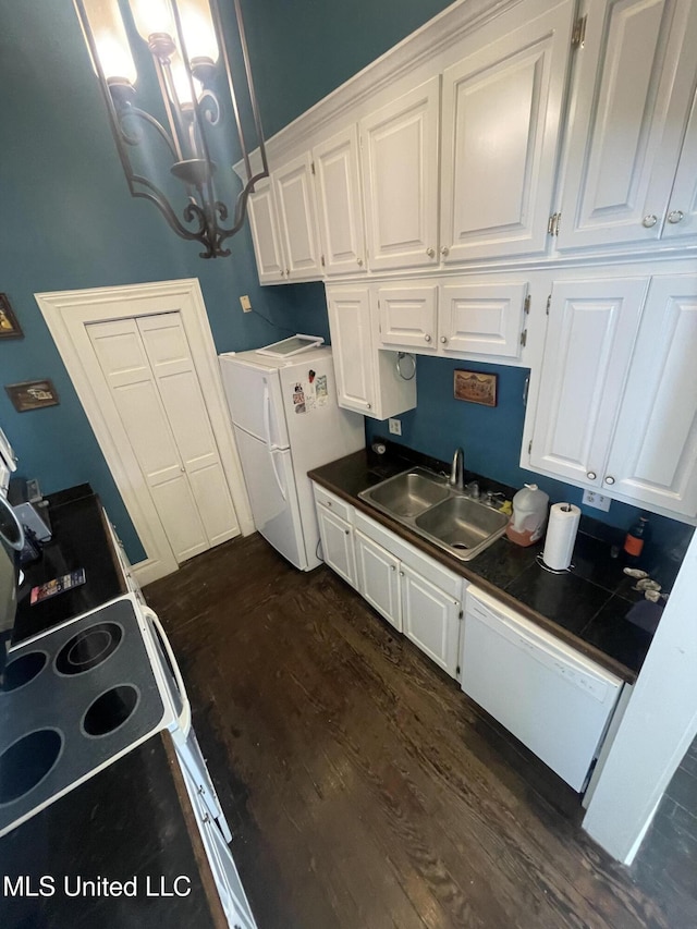 500 Franklin St, Natchez, MS 39120 - kitchen with a sink, white appliances, white cabinetry, dark wood finished floors, and a chandelier
