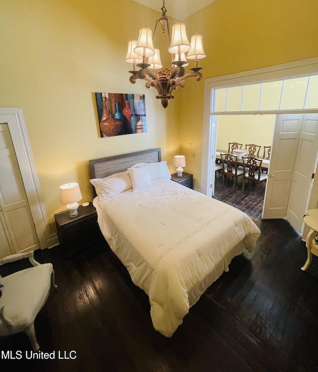 500 Franklin St, Natchez, MS 39120 - bedroom with a chandelier, dark wood-type flooring, and baseboards