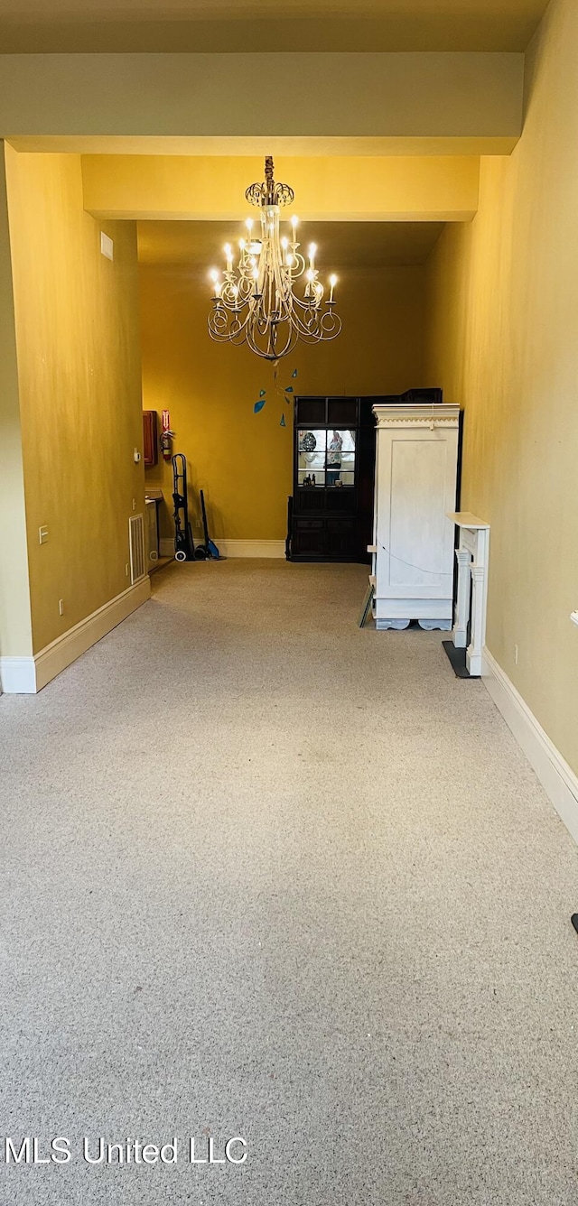 500 Franklin St, Natchez, MS 39120 - carpeted empty room with a chandelier and baseboards