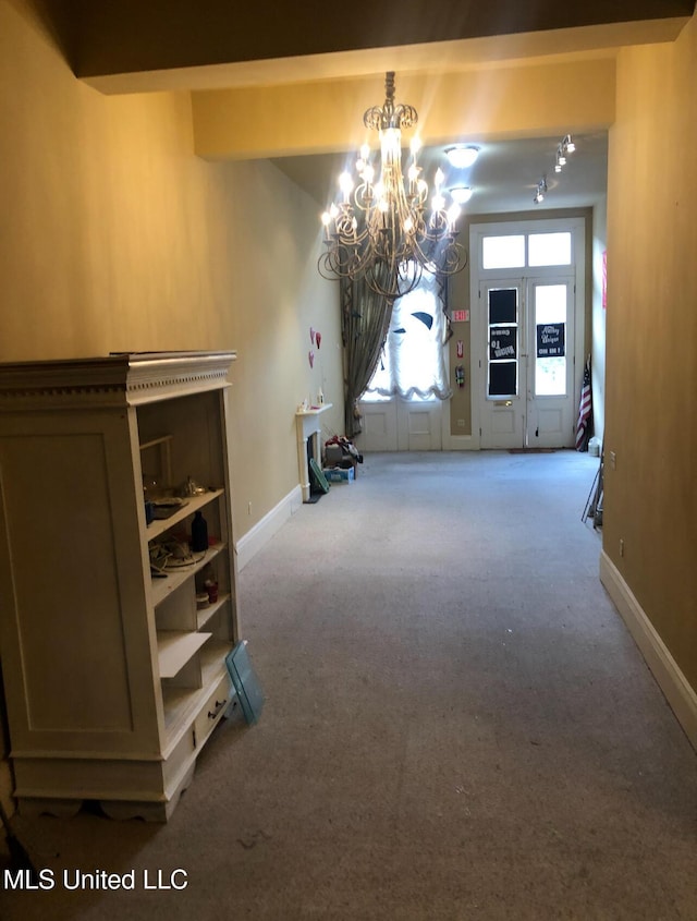 500 Franklin St, Natchez, MS 39120 - unfurnished dining area with a chandelier, carpet flooring, and baseboards