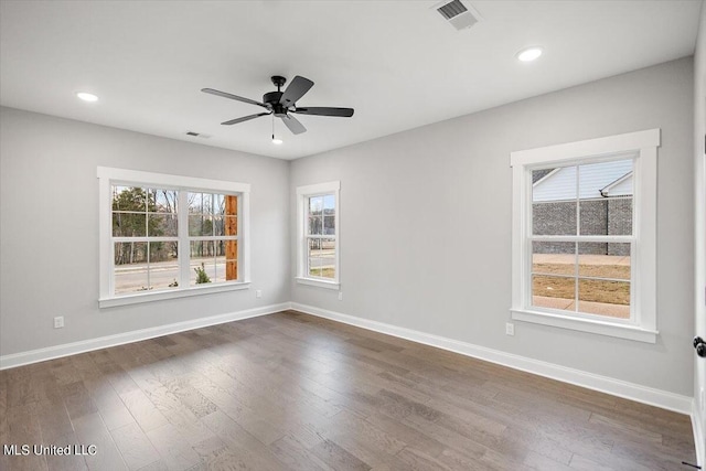 empty room with dark hardwood / wood-style floors and ceiling fan