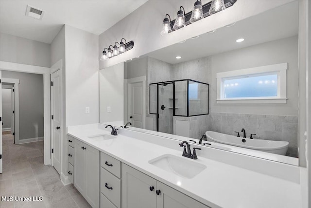 bathroom featuring vanity and shower with separate bathtub