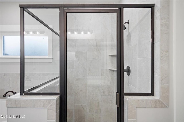 bathroom featuring a shower with shower door