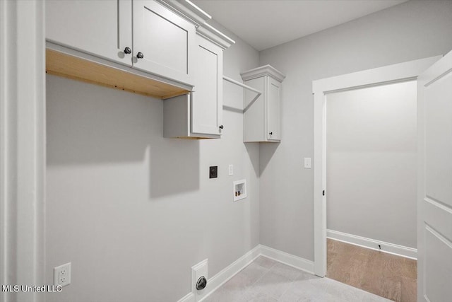 washroom featuring cabinets, hookup for a washing machine, and electric dryer hookup