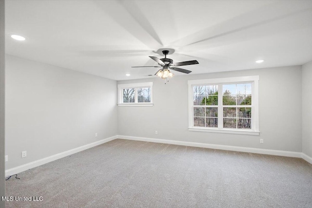 carpeted spare room featuring ceiling fan