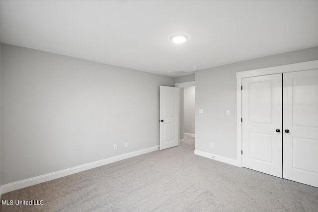 unfurnished bedroom featuring carpet floors and a closet