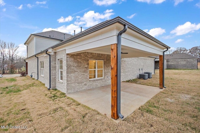 back of house with a yard, central AC, and a patio area