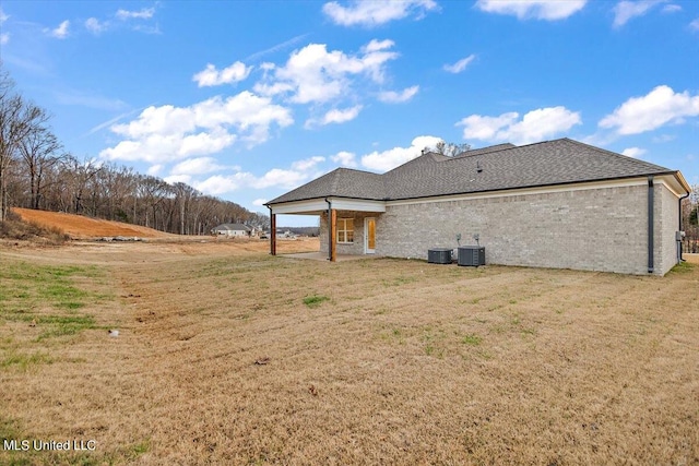 back of property featuring a yard and cooling unit