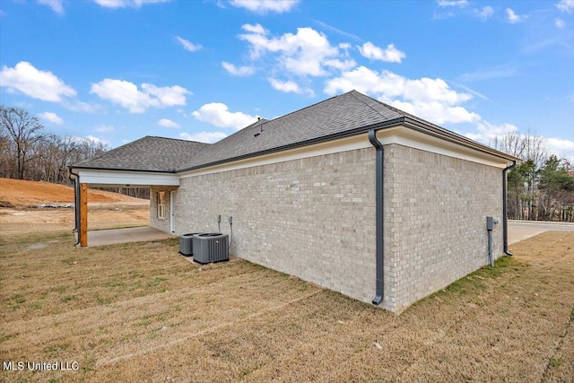 view of home's exterior featuring a patio, a lawn, and central air condition unit