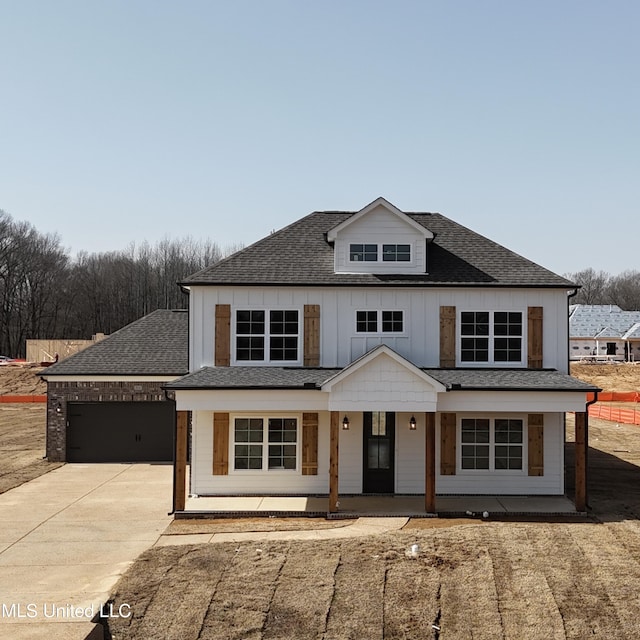 view of front facade with a garage and covered porch