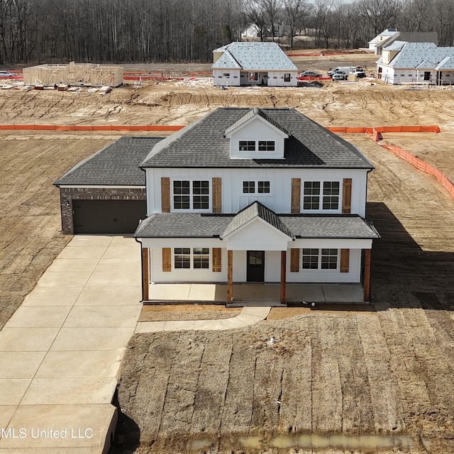 modern farmhouse style home with a porch and a garage