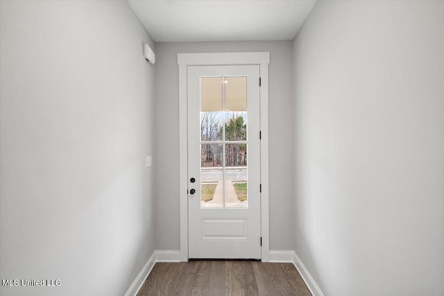 doorway with hardwood / wood-style flooring