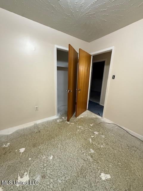 unfurnished bedroom featuring a textured ceiling