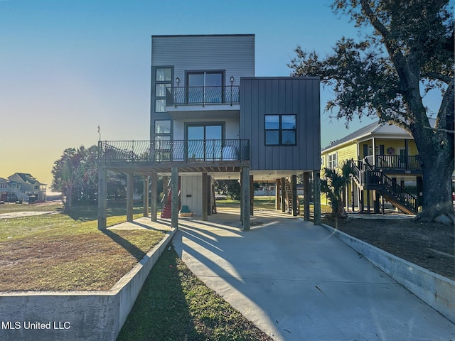 view of front of home with a balcony and a carport