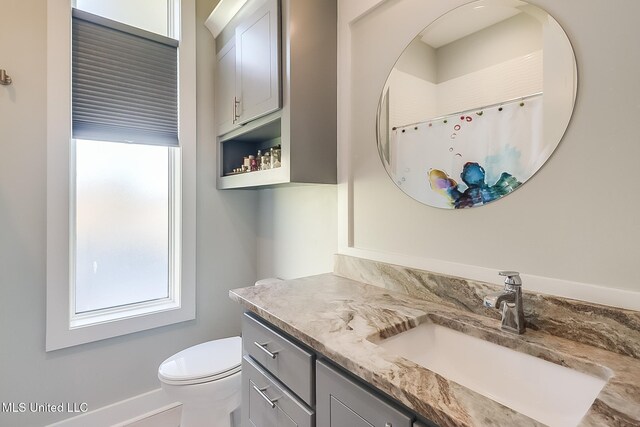 125 Miramar Ave, Biloxi, MS 39530 - bathroom with vanity, toilet, and curtained shower