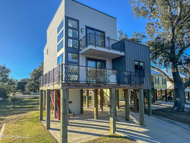 view of front of home with a carport and a balcony