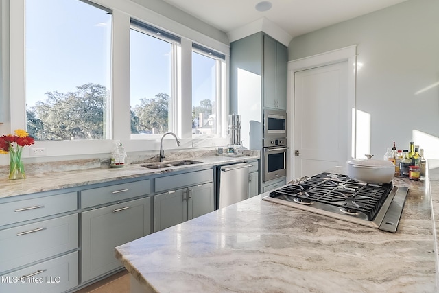 125 Miramar Ave, Biloxi, MS 39530 - kitchen featuring gray cabinets, light stone countertops, appliances with stainless steel finishes, and sink