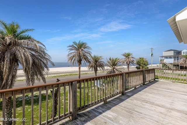 wooden terrace featuring a water view