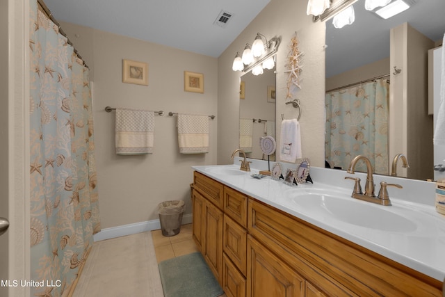 800 W Beach Blvd, Long Beach, MS 39560 - bathroom featuring tile patterned flooring, double vanity, and baseboards