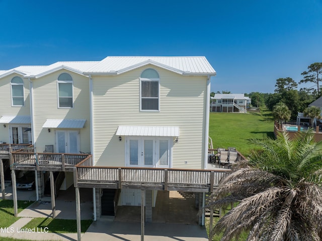 800 W Beach Blvd, Long Beach, MS 39560 - rear view of property featuring french doors, a wooden deck, and a carport