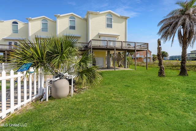 rear view of property with a deck and a lawn