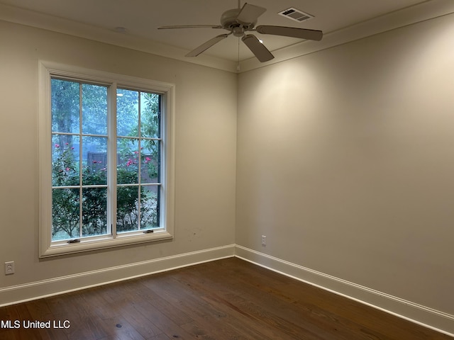 empty room featuring crown molding, dark hardwood / wood-style floors, and ceiling fan