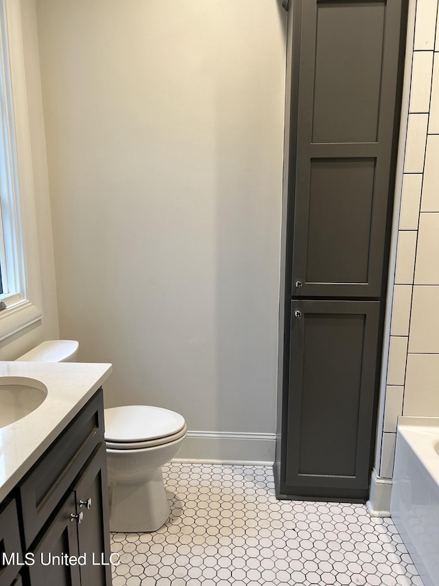 full bathroom with toilet, plus walk in shower, vanity, and tile patterned floors