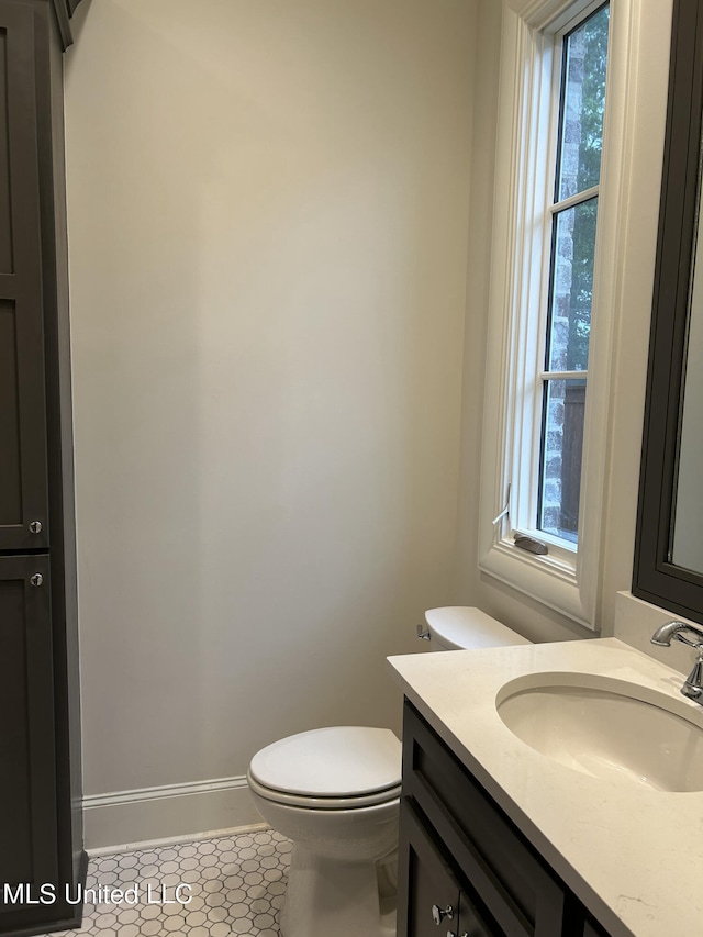 bathroom featuring vanity, toilet, and tile patterned floors