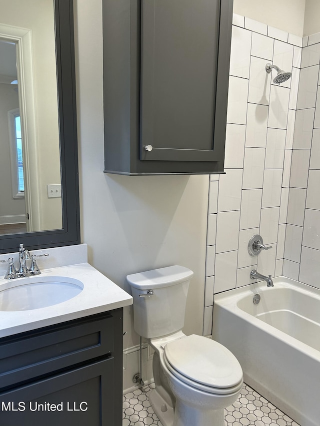 full bathroom featuring toilet, tiled shower / bath combo, vanity, and tile patterned floors