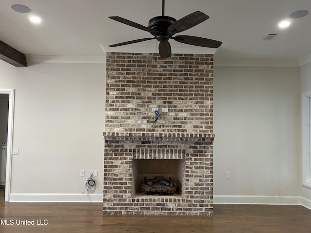 unfurnished living room with crown molding, dark hardwood / wood-style floors, a brick fireplace, and ceiling fan