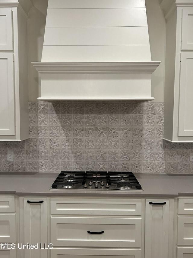 kitchen with white cabinetry, stainless steel gas cooktop, and tasteful backsplash