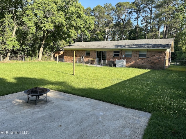 11086 E Taylor Rd, Gulfport, MS 39503 - rear view of house featuring a fire pit, a patio, and brick siding