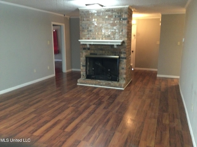 unfurnished living room featuring dark wood-type flooring, crown molding, and a fireplace