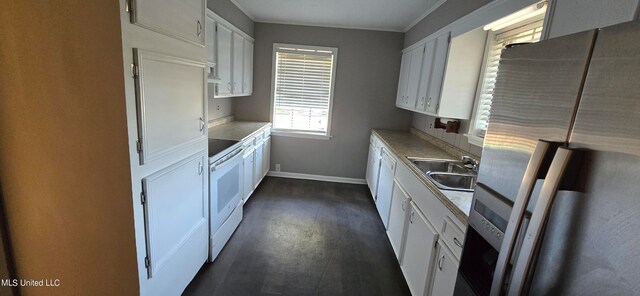 kitchen featuring stainless steel fridge, white cabinetry, dark wood-type flooring, electric stove, and sink