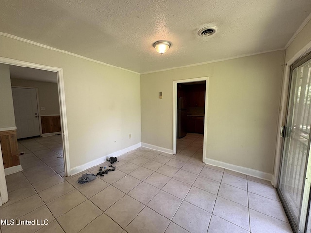 3435 Casa Grande Cir, Jackson, MS 39209 - empty room featuring a textured ceiling, crown molding, light tile patterned floors, and baseboards