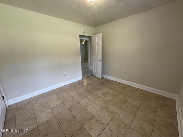 3435 Casa Grande Cir, Jackson, MS 39209 - unfurnished room with a textured ceiling, baseboards, and tile patterned floors