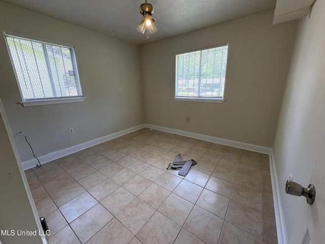 3435 Casa Grande Cir, Jackson, MS 39209 - spare room featuring light tile patterned floors, baseboards, and ceiling fan