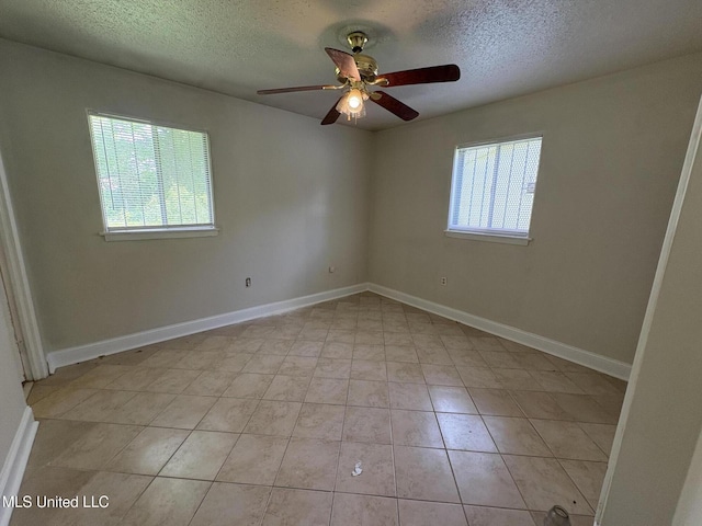 3435 Casa Grande Cir, Jackson, MS 39209 - spare room with plenty of natural light, a textured ceiling, ceiling fan, baseboards, and light tile patterned floors