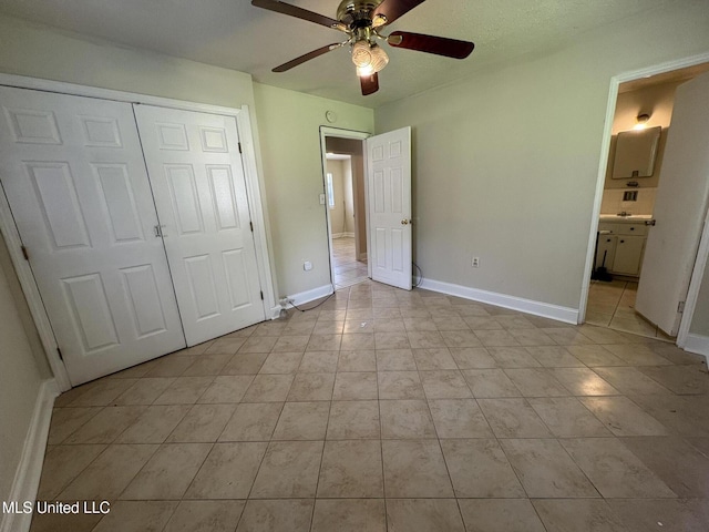 3435 Casa Grande Cir, Jackson, MS 39209 - unfurnished bedroom with light tile patterned floors, a closet, baseboards, a ceiling fan, and connected bathroom