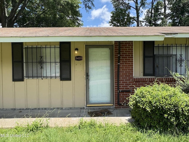 3435 Casa Grande Cir, Jackson, MS 39209 - property entrance with brick siding, board and batten siding, and covered porch