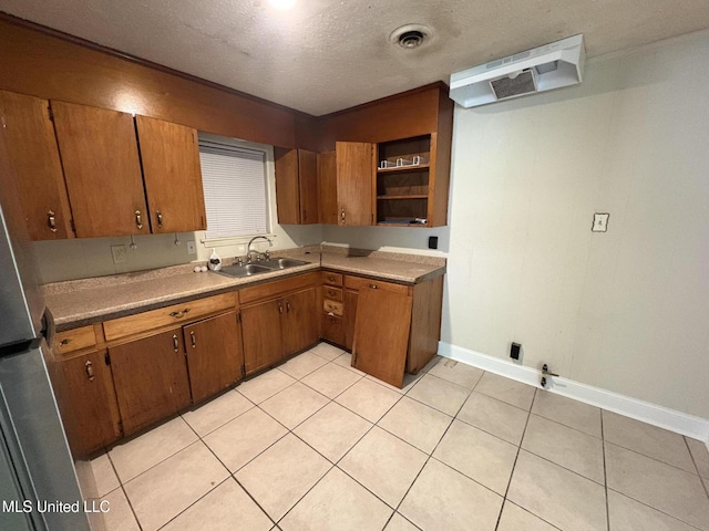 3435 Casa Grande Cir, Jackson, MS 39209 - kitchen with a sink, brown cabinetry, baseboards, open shelves, and light tile patterned flooring