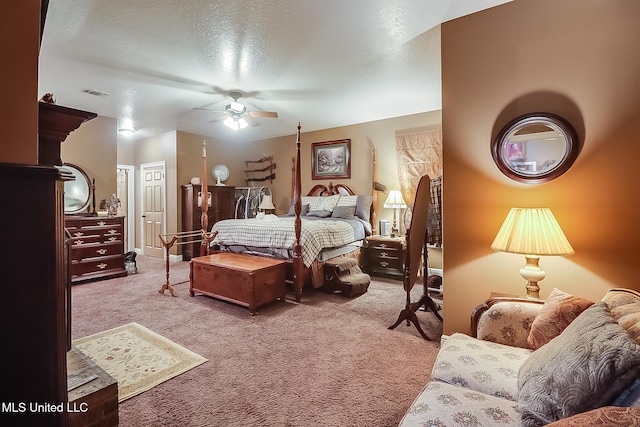 bedroom featuring carpet flooring, ceiling fan, and a textured ceiling