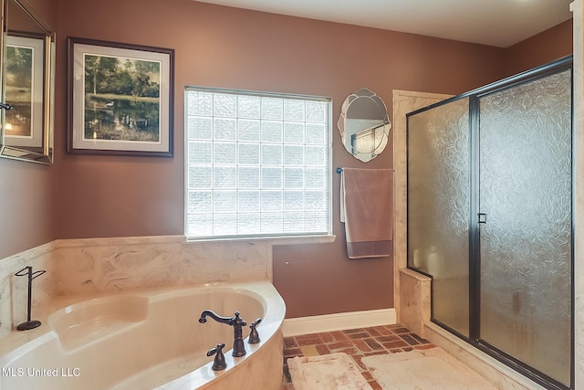 bathroom featuring separate shower and tub